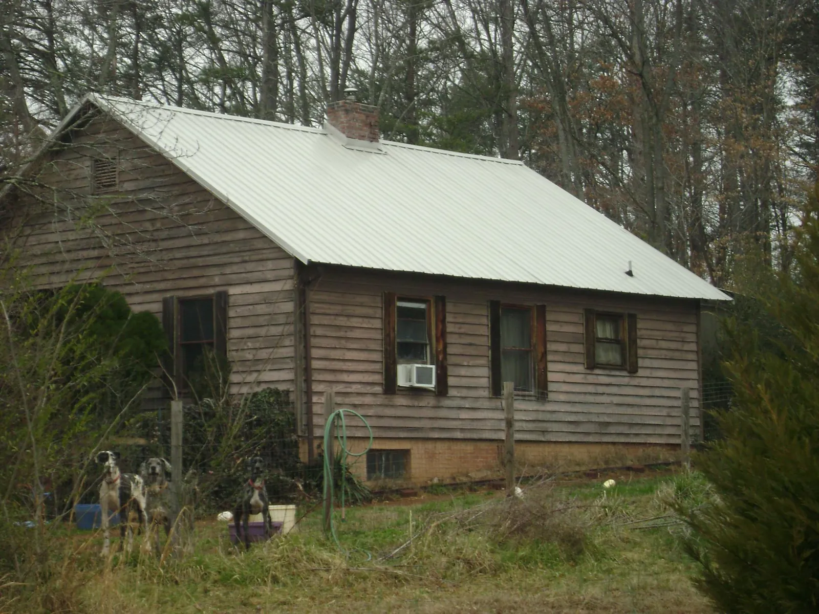 White metal roof on an old wood sided farmhouse, from a Metal Roof Installation job in Dorchester